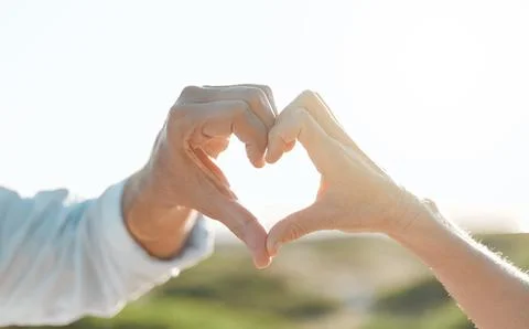 Because Id be broken without you. an unrecognizable couple forming a heart shape Stock Photos