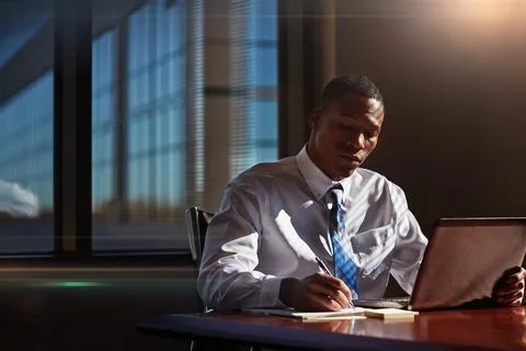 Become as knowledgeable as you possibly can. a businessman taking notes while Stock Photos