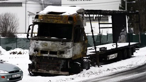 Becva Czech Rep Jan 7th 2022 Burnt truck in snow by the road side. Tractor and Stock Footage 170018476