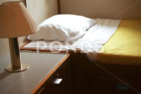 Bed and lamp in hut Stock Photos
