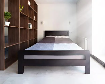 Bed in apartment Stock Photos