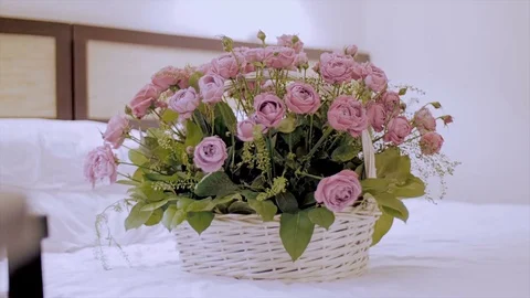 On the bed a basket of flowers. Stock Footage 73892108