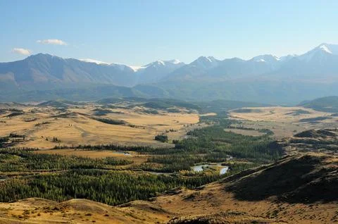 The bed of a beautiful river bending flows through the autumn valley, surro.. Stock Photos