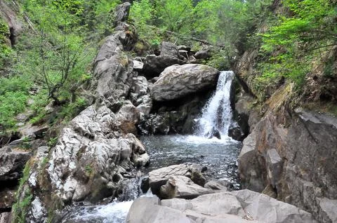The bed of a beautiful river flowing down from the mountains, sandwiched in.. Stock Photos