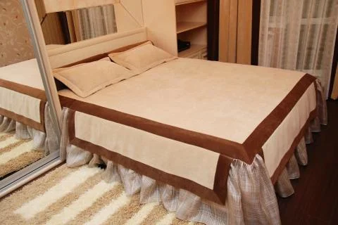 Bed in the bedroom in shades of brown Stock Photos