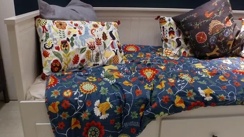 A bed with bright pillows and a blanket. Stock Footage 79164381