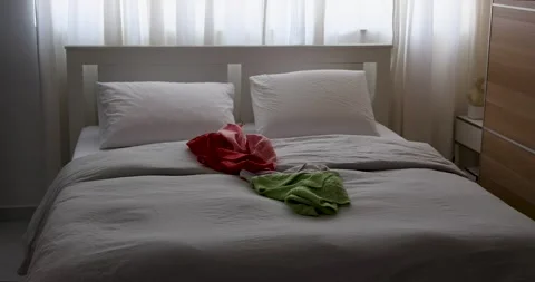 Bed with Clothes Thrown On It. Stock Footage 277969408