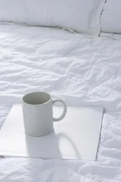 Bed with coffee cup on tray Stock Photos