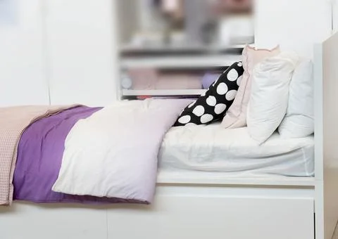 Bed concept. White themed bed sheets and pillows. Stock Photos
