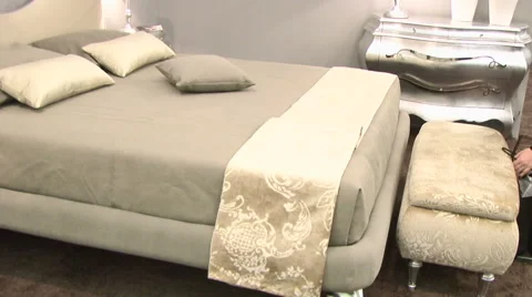 The bed is covered by a down comforter and throw pillows Video stock 53454413