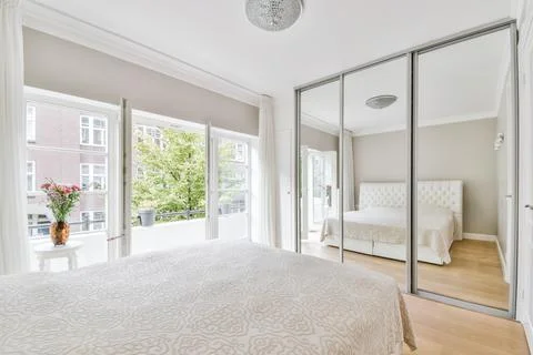 Bed covered with a soft blanket Stock Photos