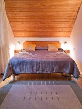 Bed in a cozy loft Stockfoto's