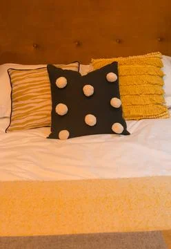 Bed with Cushions Stock Photos