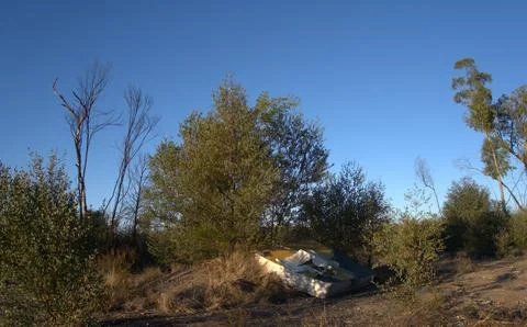 Bed dumped in the bush Stock Photos