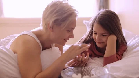 On the bed eating marshmallow Stockbeeldmateriaal 74635600