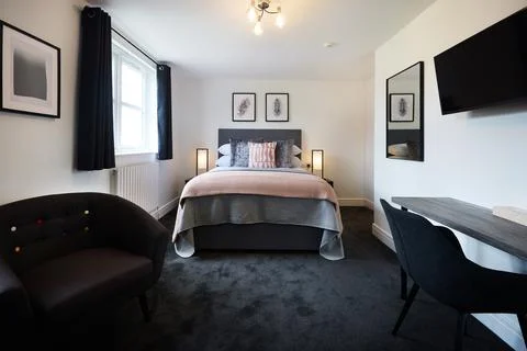 Bed, empty room and hotel furniture for accommodation for travel comfort for Stock Photos