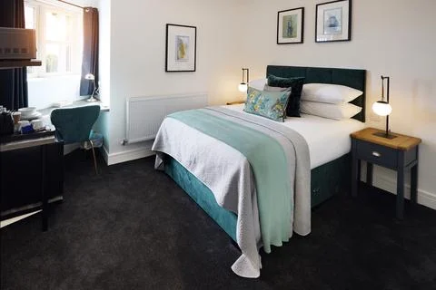 Bed, empty room and hotel interior design for accommodation for travel comfort Stock Photos