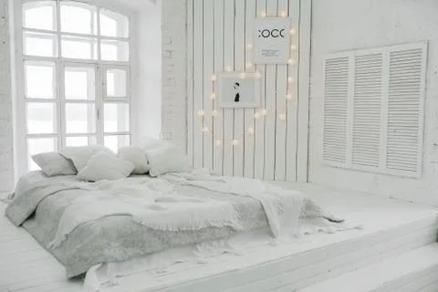 Bed on the floor. Modern Studio design Stock Photos