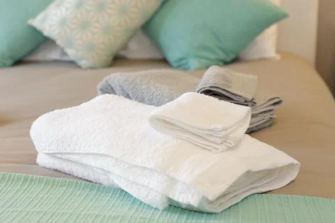 Bed with fresh towels Stock Photos