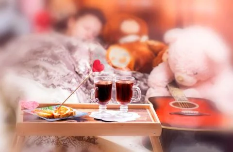 Bed with fruit breakfast on foreground. Stock Photos