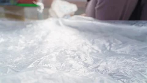 A bed in a greenhouse covered with plastic wrap in early spring, close-up Stock Footage 305689835