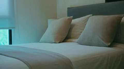 The bed has white sheets Stock Footage 345400859