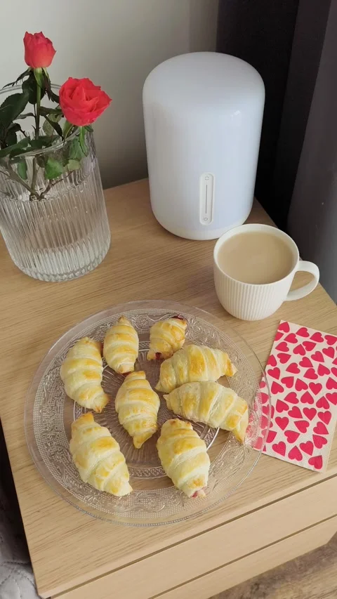 Bed with heart mocha mousse balloons, coffee, croissants, roses valentine's day Stock Footage 301627110
