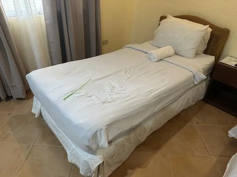Bed inside of the hotel Stock Photos