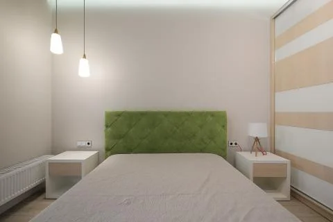 Bed in the modern bedroom interior Stock Photos