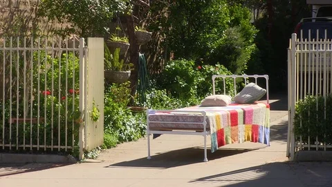 Bed outside with trees Stock Footage 84961303