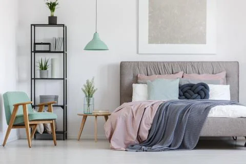 Bed with pastel bedding Stock-Fotos