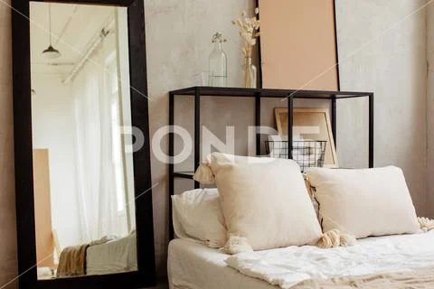 Bed with pillows and beautiful linens of warm colors Stock Photos