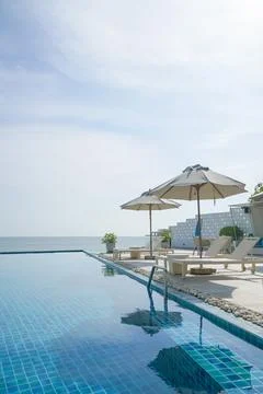 Bed pool around swimming pool with sea background Stock Photos