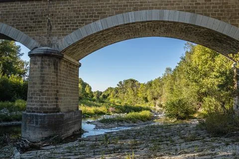 Bed of a river passing under a bridge Stock Photos