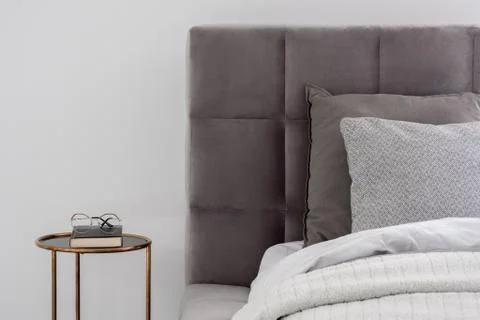 Bed with round bedside table Stock Photos