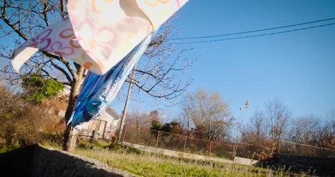 Bed sheets on a clothes line moving gently with the wind Stock Footage 230049434