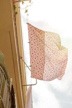 Bed sheets drying in the street Stock Photos