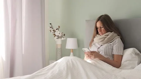 In bed sick drained womans sorrow fills room as she communicates through her Stock-Footage 272446596