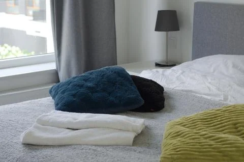 Bed with soft pillows. Interior stylish room with big bed Stock Photos