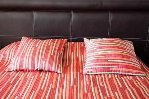 Bed with two pillows and a blanket Foto stock