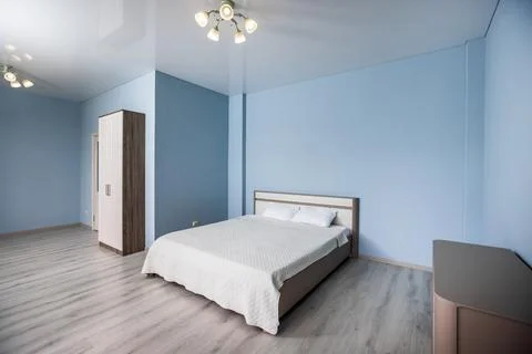 A bed with a white comforter and two pillows Stock Photos