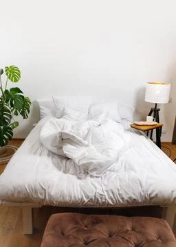 Bed with white linens Stock Photos