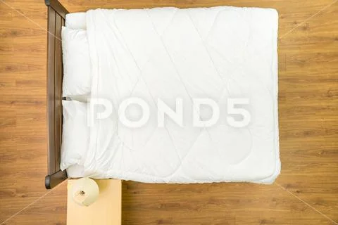 The bed with a white linens. View from above Stock Photos