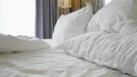 A bed with white sheets and pillows Stock Footage 313417115