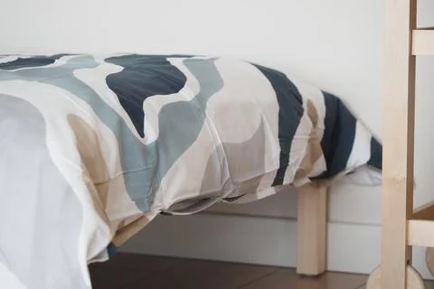 Bedding and bed frame in simple room setting Foto stock