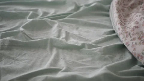 Bedding and fabric textures on a bed in a home setting Stock Footage 346194910