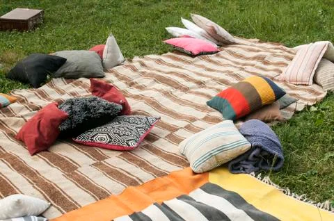 Bedding with different pillows on meadow Stock Photos