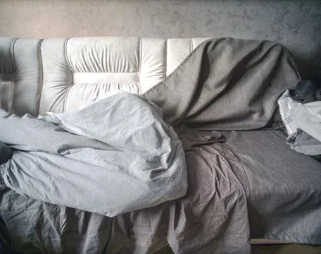 Bedding on old sofa 写真素材