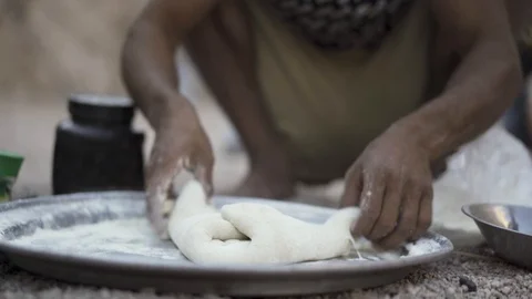 Bedouin is baking traditional bread on open fire in the mountains. Shot Stock Footage 121239467