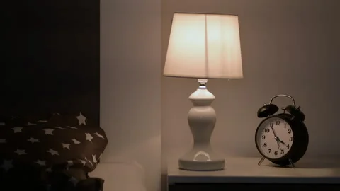 Bedroom bedside lamp and clock at 4 o'clock in the morning for insomnia conce Stock Footage 160047917